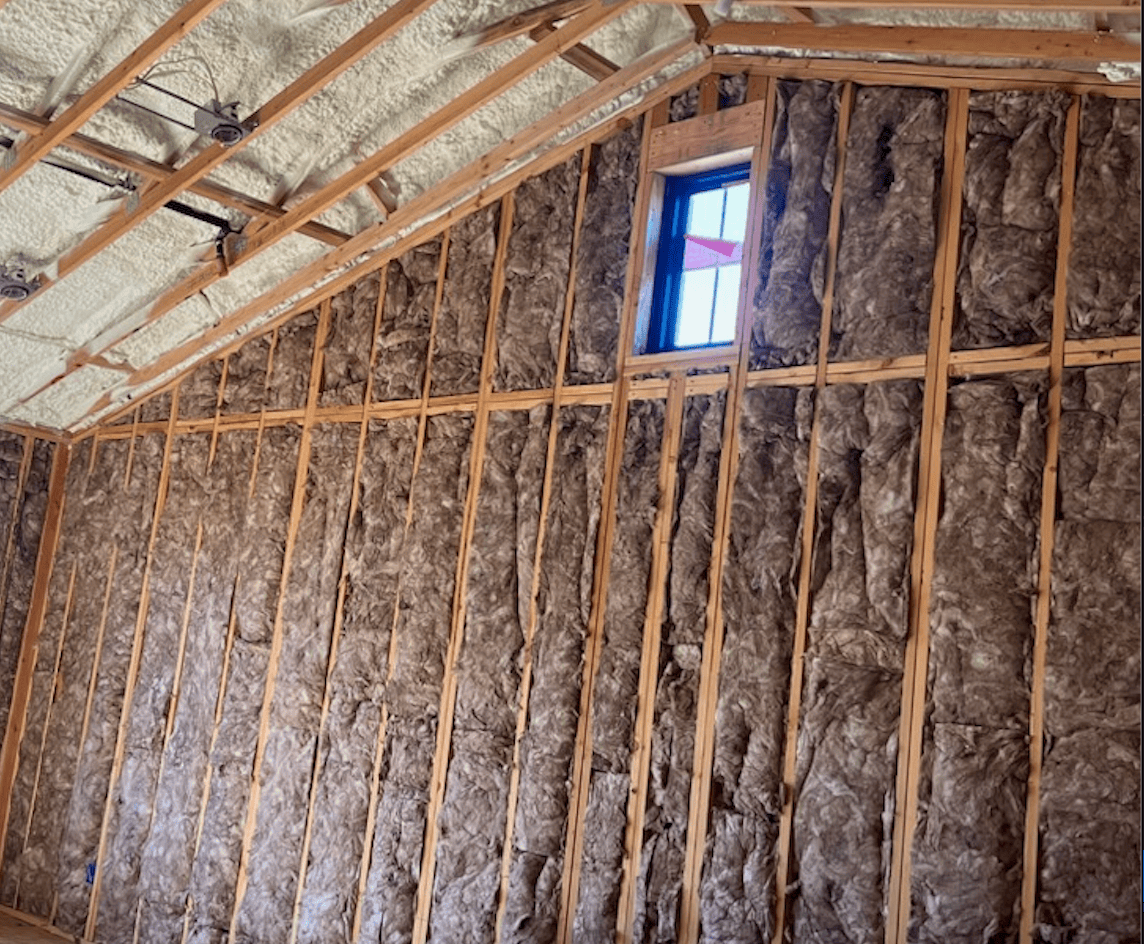 image of a builing structure with spray foam and fiberglass insulation.