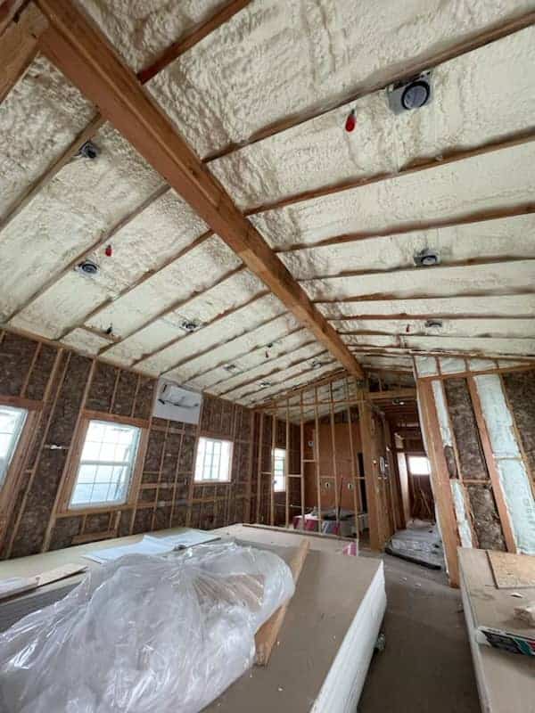 image of a builing structure with spray foam and fiberglass insulation.